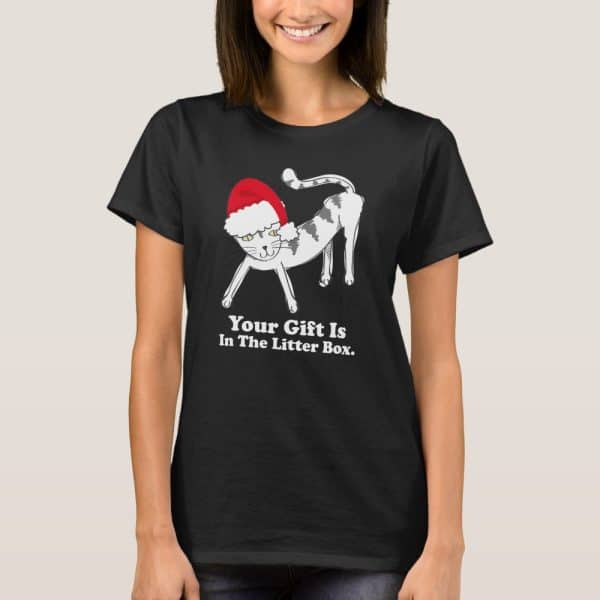 Black T-Shirt Featuring A Cartoon Cat Wearing A Santa Hat. Text Below Reads Your Gift Is In The Litter Box.