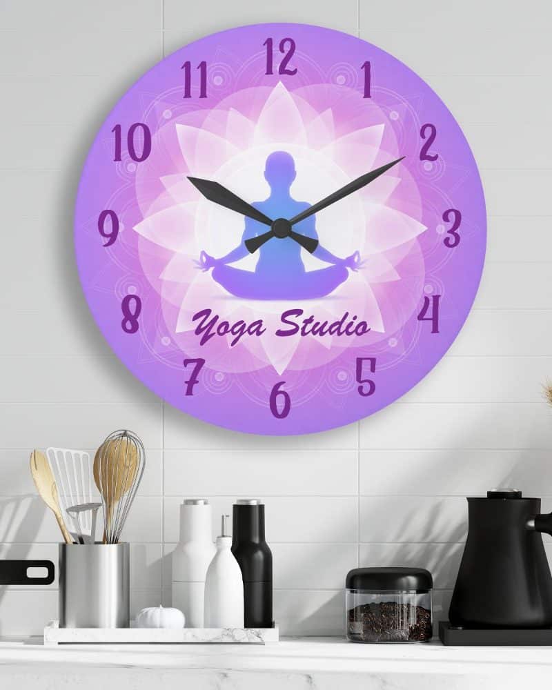 Purple yoga studio clock featuring a silhouetted person in a lotus position.