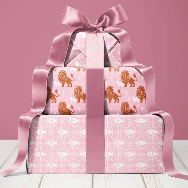 Stack Of Gifts Wrapped In Pink Paper With Religious Symbols And Tied With A Large Pink Ribbon.