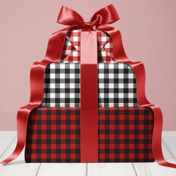 Stack Of Three Gifts Wrapped In Red And Black Plaid Paper, Tied With A Large Red Ribbon.